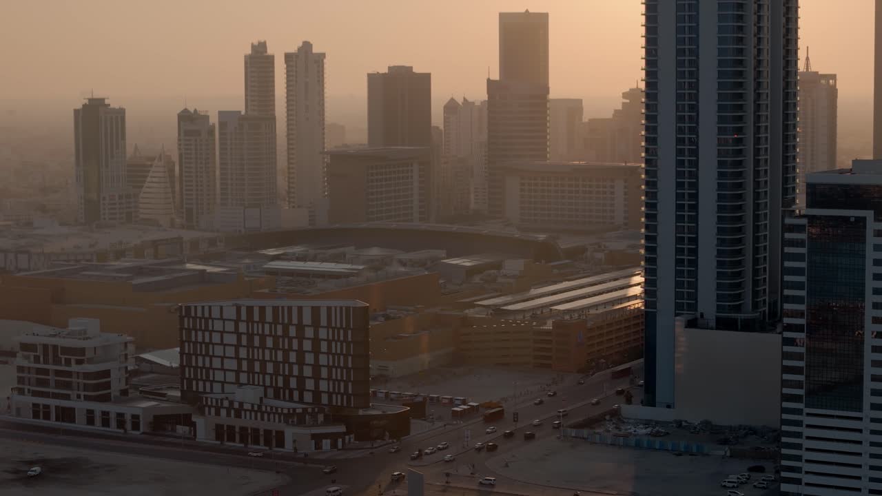 Bahrain, backlit skyscrapers in hazy warm afternoon light, Sanabis and Seef neighbourhoods