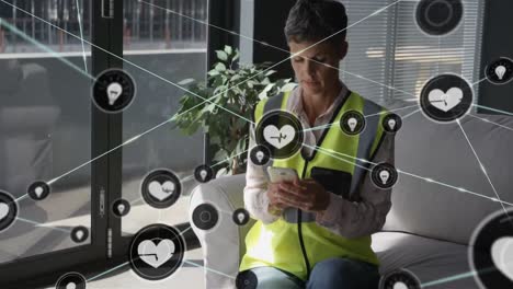 Animation-of-network-of-connected-heart-icons-over-caucasian-woman-in-high-vis-vest-using-smartphone