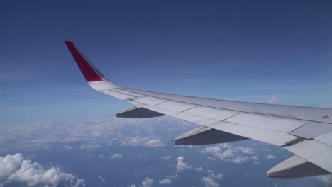 clouds and sky as seen through window of an aircraft