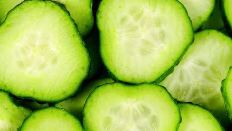 cucumber, sliced pieces of green cucumber stacked on a hill rotate. circles of fresh cucumbers as food background