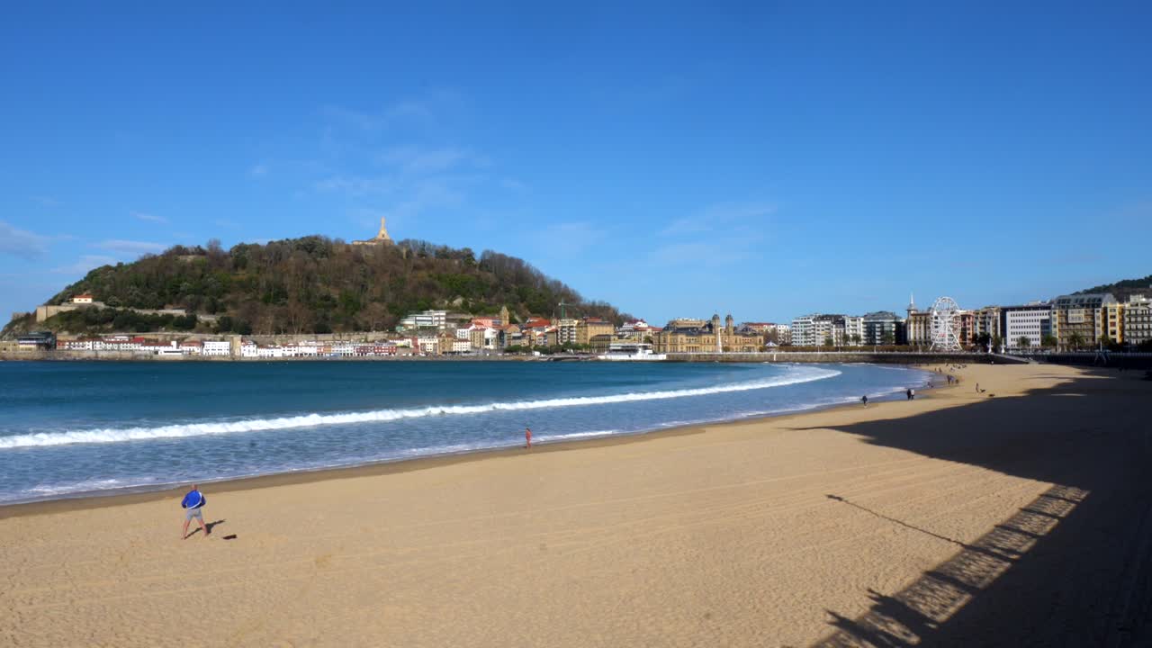 Paesaggio urbano fronte spiaggia con sfondo montano
