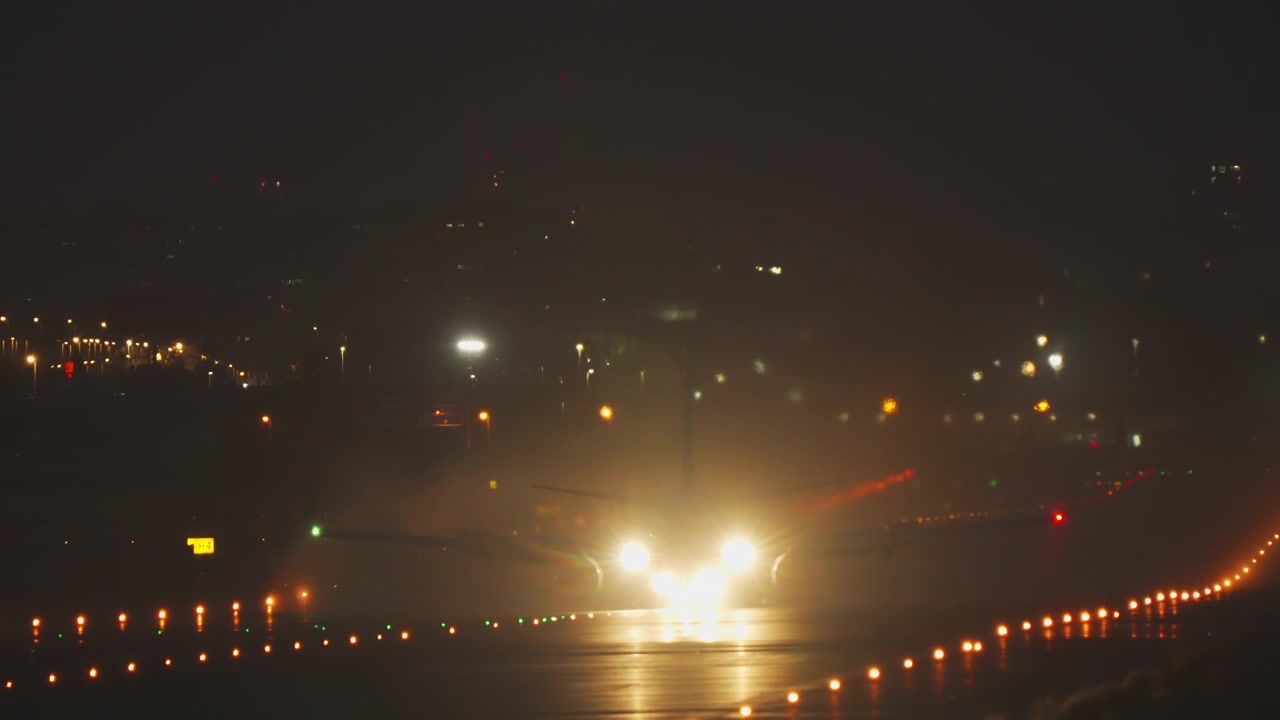 Airplane landing lights on a runway at night