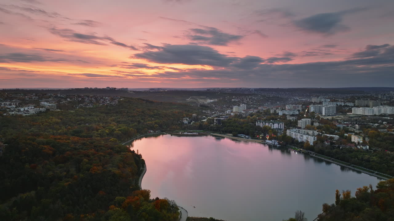 Close up of the hands of an old woman sitting in a pleated, red skirt
