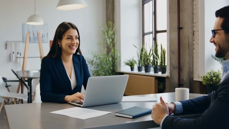 A professional woman smiling and engaging in a business meeting or interview