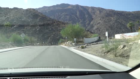 driving towards california mountains looking through the windscreen, hot summers day with a nice blue sky. shot in 120 frames per second.