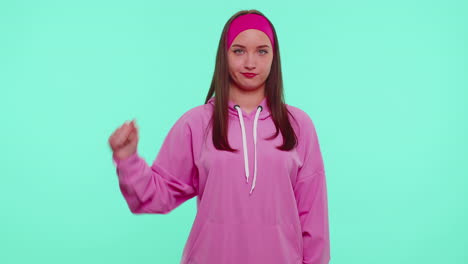 Upset-girl-in-pink-hoodie-showing-thumbs-down-sign-gesture,-disapproval,-dissatisfied,-dislike