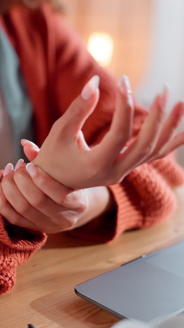 Close-up of Person Rubbing Painful Wrist at Desk