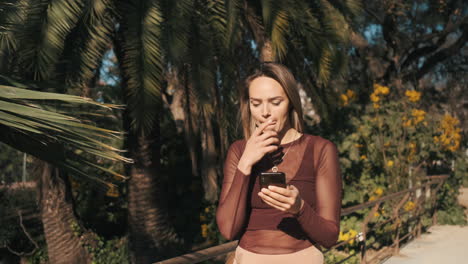 charming pensive woman texting on the phone and laughing.