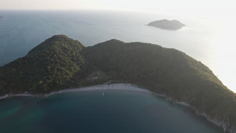 Sunset-summer-landscape-in-Japanese-Island-drone-aerial-vibrant-sunset-skyline-sun-shining-above-quiet-pacific-ocean,-asian-travel-destination-Wakayama