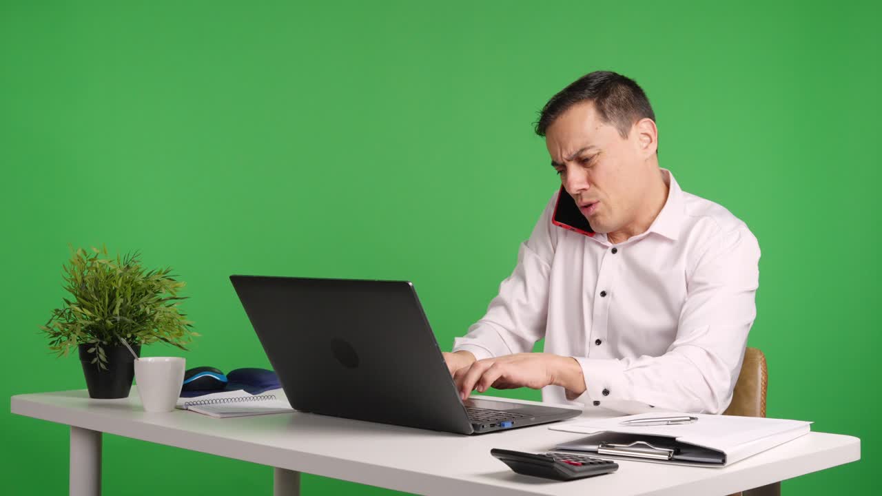 Office worker arguing on phone with green screen