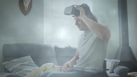 Spot-of-light-against-caucasian-handicapped-man-wearing-vr-headset-playing-with-his-dog