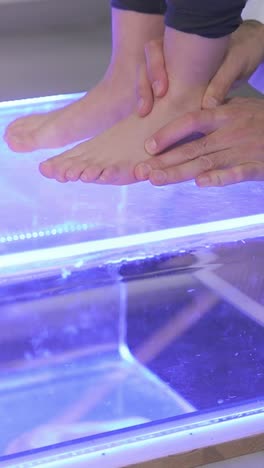 child's feet being examined on a foot scan device