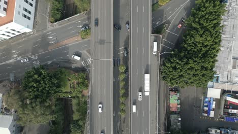 Sydney-city-intersections-and-car-bridge-with-busy-traffic-highway-Aerial-static-top-down-establishing-shot