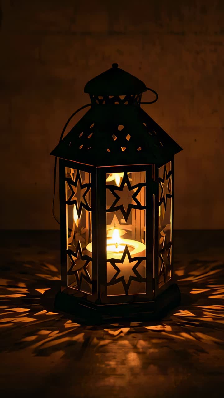 Vertical video: Flickering tealight in metal lantern casting star-shaped shadows on table and wall