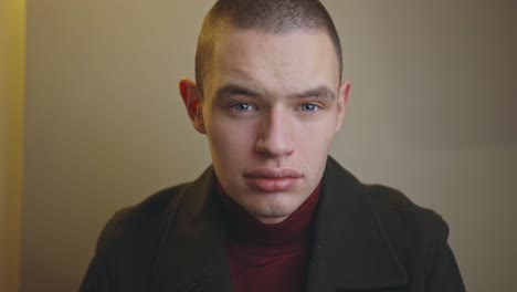 serious young man with grey eyes looking straight at the camera