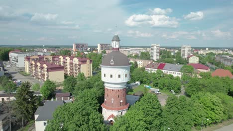 drone flying backwards revealing water tower in elk, built in 1895