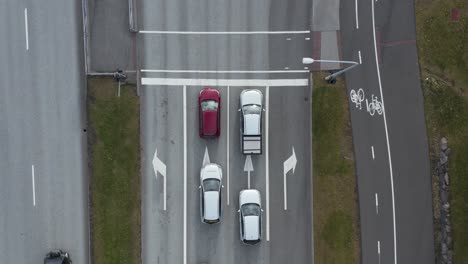 Cars-waiting-for-red-traffic-light-in-suburban-Reykjavik,-top-down