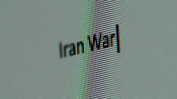 Iran War words typed out on computer screen extreme close up gritty macro