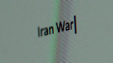 iran war words typed out on computer screen extreme close up gritty macro