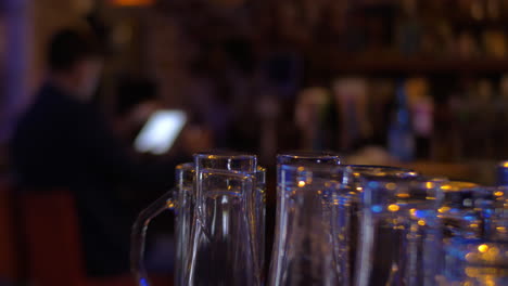 glassware and man with pad in cafe