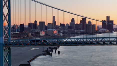 semi truck passing ambassador bridge during sunset, export and import concept, aerial view