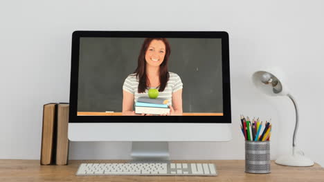 animation of a computer monitor showing caucasian woman holding a pile of books