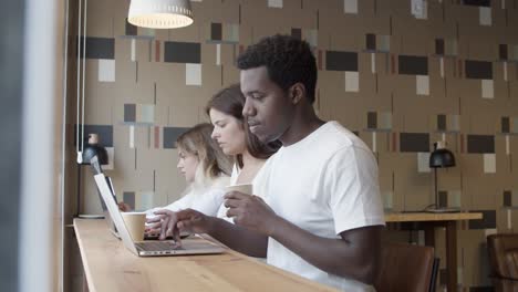 focused african american professional sitting at counter