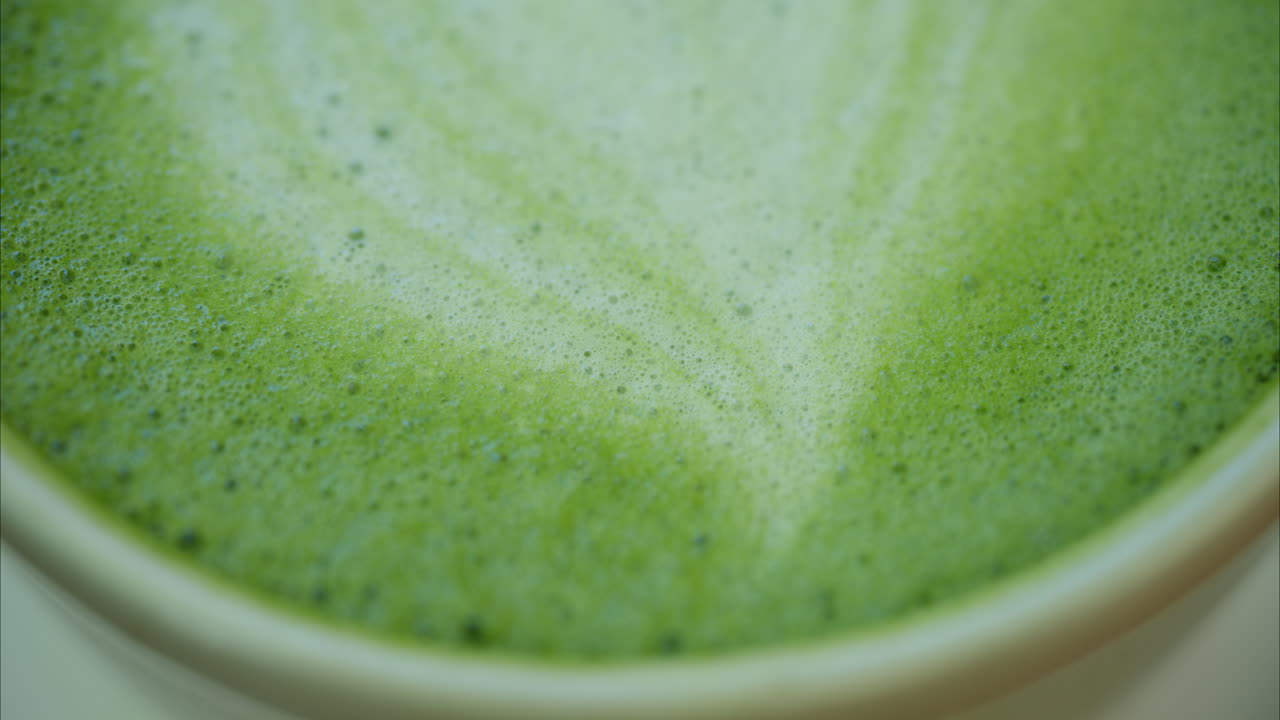 Close up of a heart latte art on a matcha latte