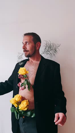 man in a black suit with flowers