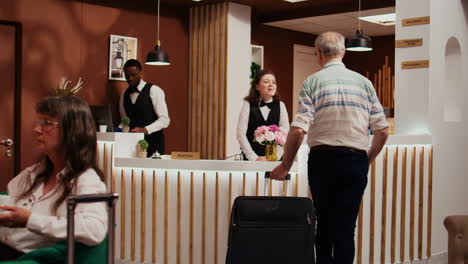 senior man entering hotel lobby