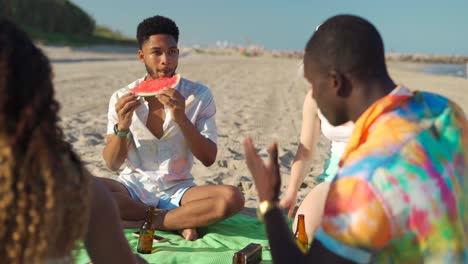 diverse friends eating fruits and listening to guitarist