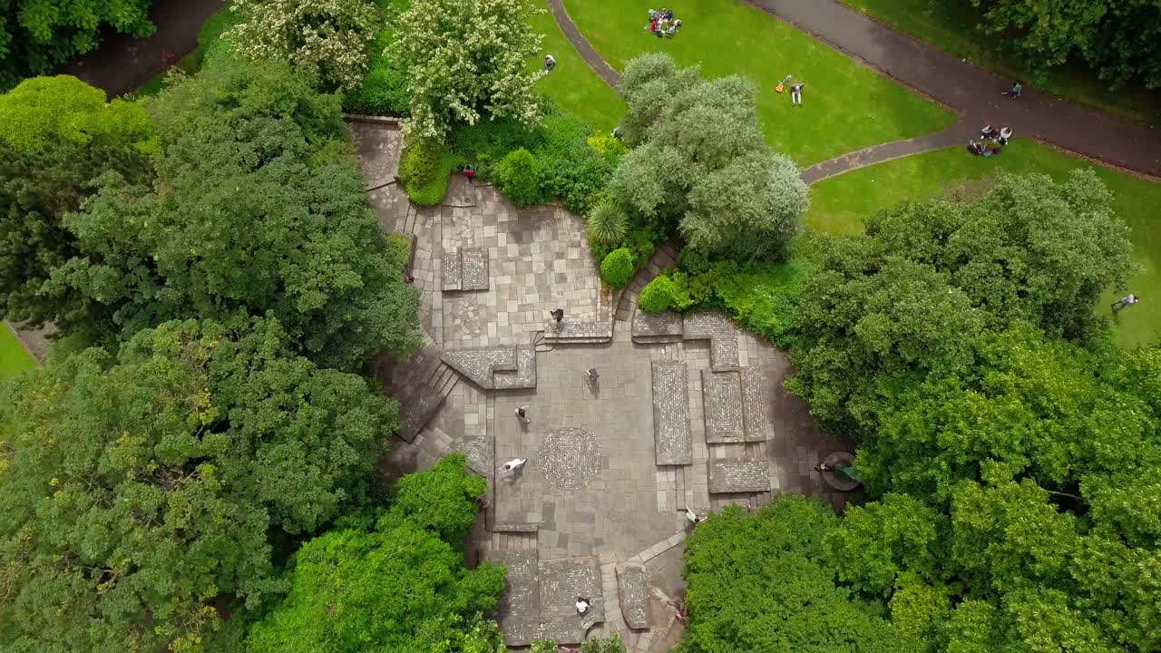 A group of young people doing Parkour and jumping on walls at the beautiful Yeats Memorial, Dublin Ireland