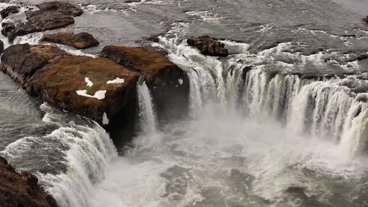 Goðafoss waterfall on Skjálfandafljót river, Iceland, with rocky terrain and cascading water