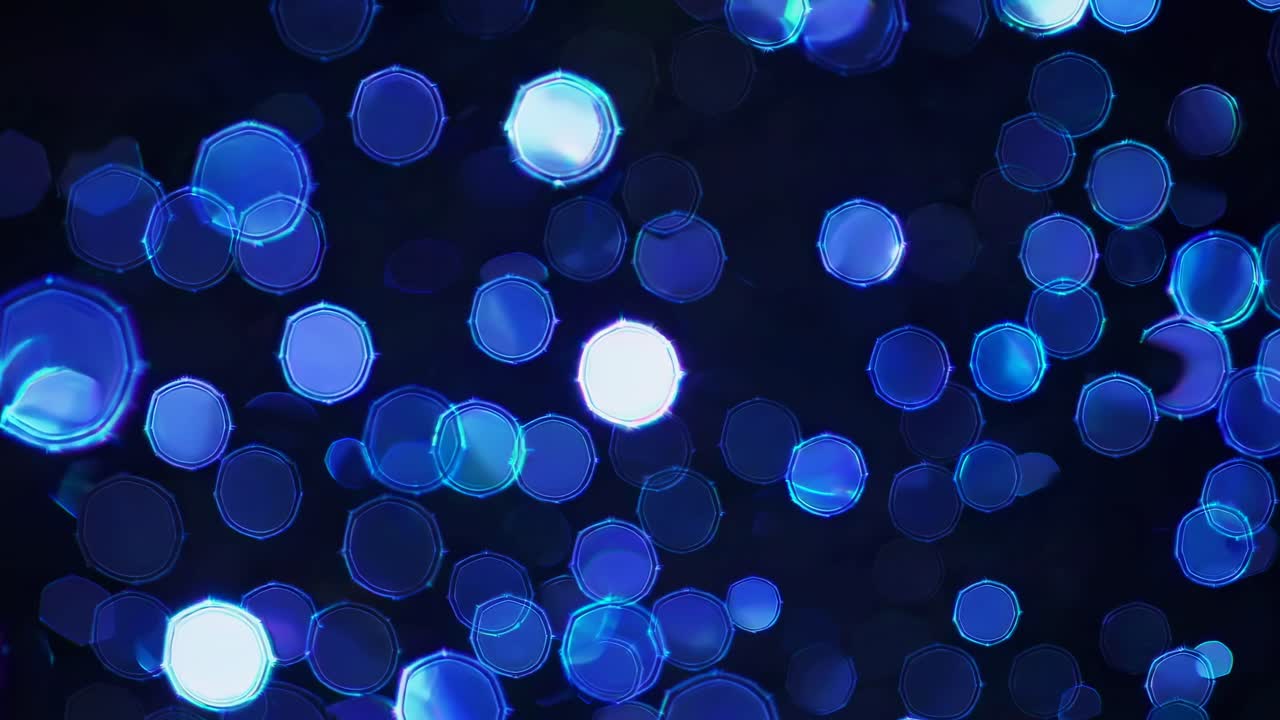 Abstract video with a bokeh effect, featuring glowing blue circles