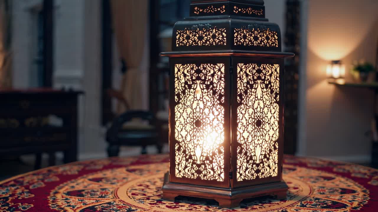 Warm light emanates from an intricately designed lantern, placed on a table adorned with a rich, patterned tablecloth, evoking the serene ambiance of Ramadan