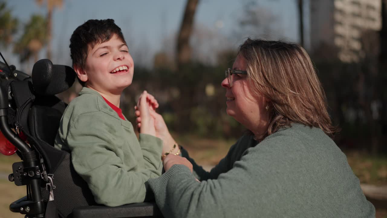 A touching moment between a child in a wheelchair and a caregiver