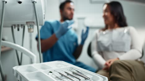 dentist talking with patient in dental office