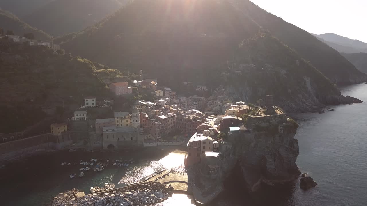 droneshot upwards motion downwards tilt of a coastline village in italy at sunrise 4k