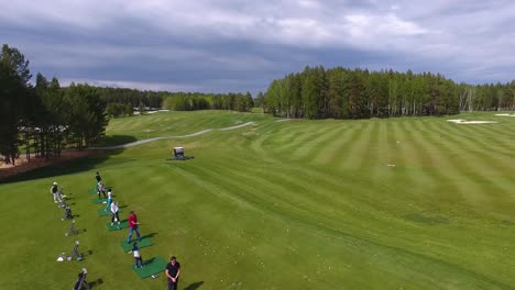 golfers practicing on a driving range