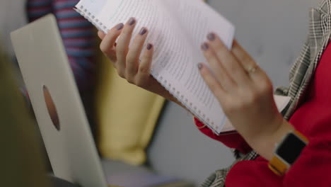 close-up-business-woman-hands-reading-corporate-project-document-turning-pages-browsing-information-in-office