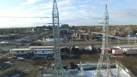 Aerial-panning-view-of-an-electric-post-power-plant-transformer-station-located-in-the-industrial-area,-in-winter,-Canada