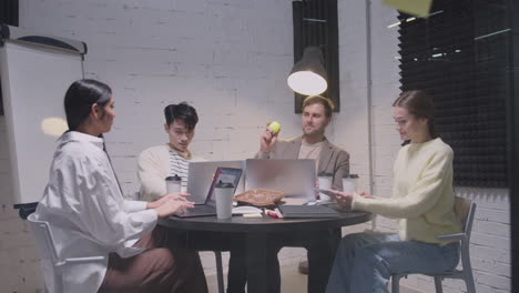 group of multiethnic colleagues having a team meeting and passing tennis ball to each other