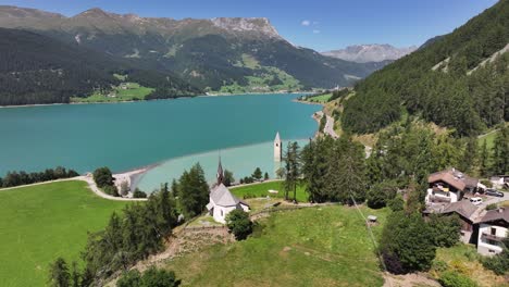 famous flooded - in 1950- bell tower from the 14th century of graun in the reschen lake in south tyrol, italy