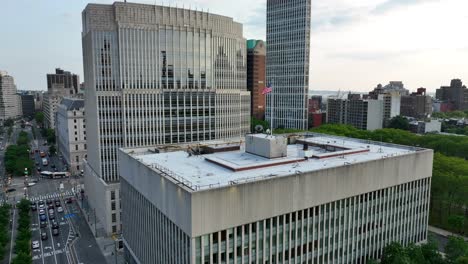 Aerial-approach-towards-large-United-States-government-building-with-American-flag-waving