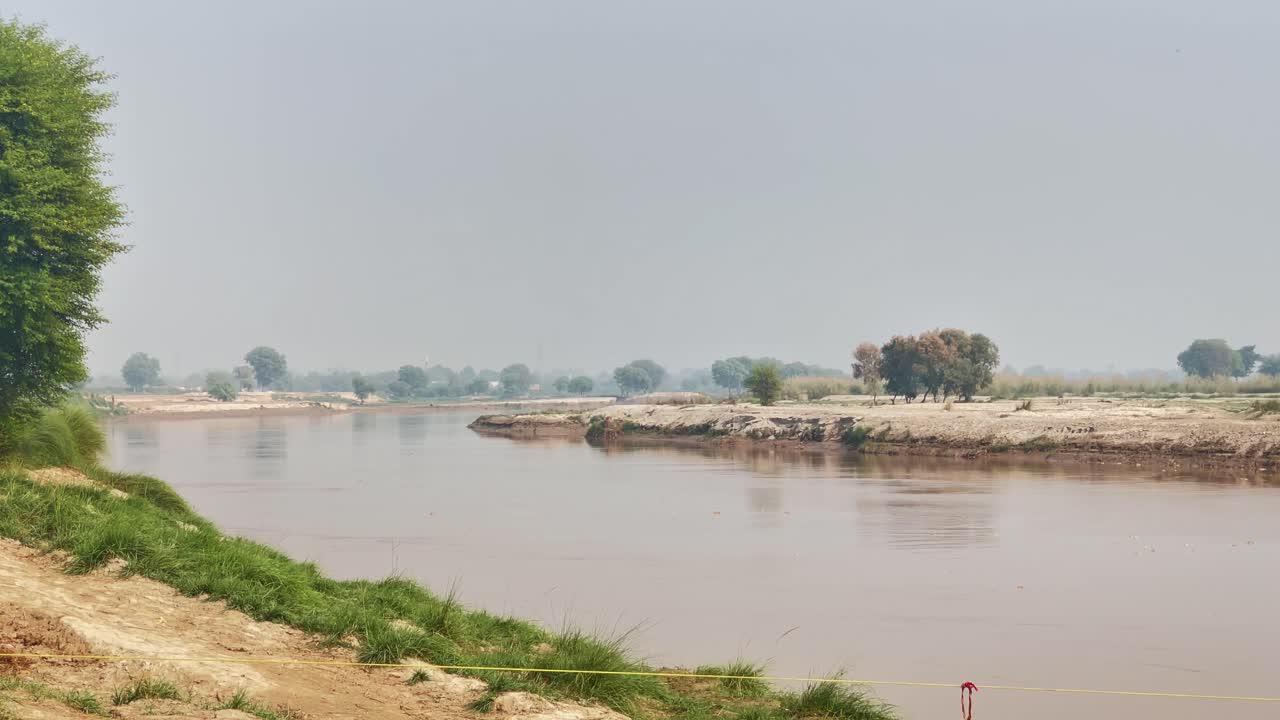 Profile view of Chenab River on a sunny afternoon in Bahawalpur, Pakistan