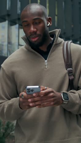 man using smartphone in city