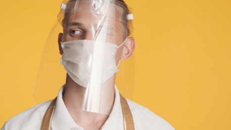 man nodding his head with two face masks