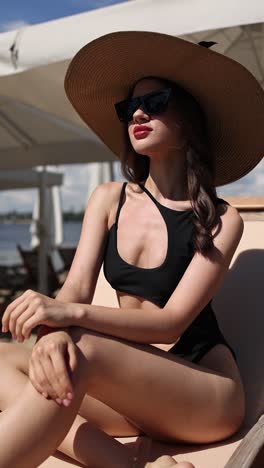 woman in a swimsuit and hat at the beach