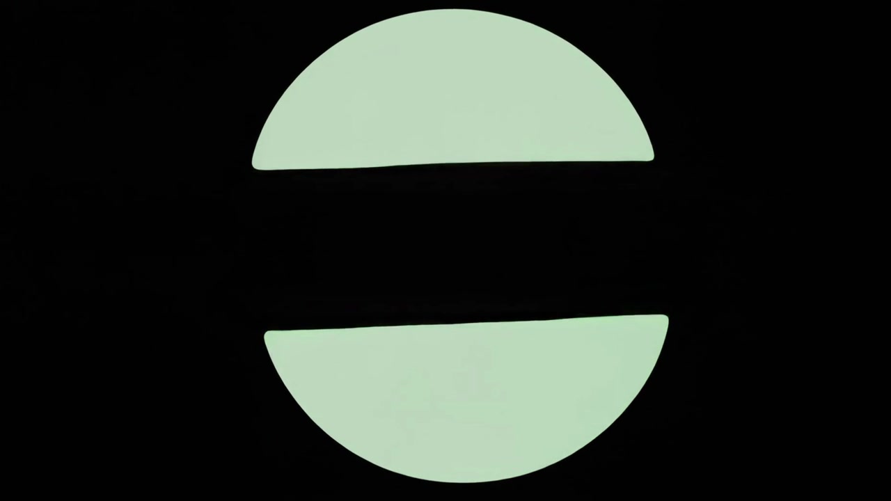 Abstract Animation of Green Geometric Shapes Morphing on Black Background