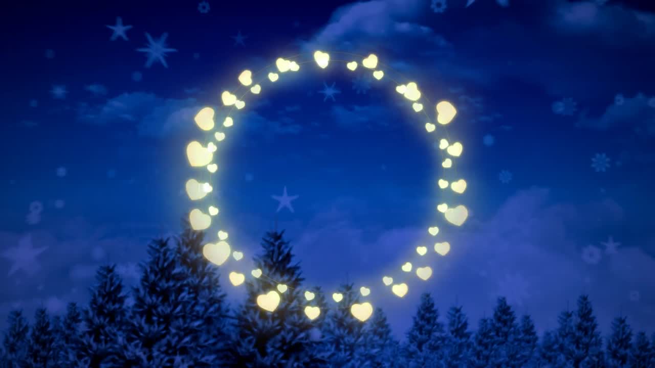 Animation of fairy light frame with copy space over fir trees and winter scenery
